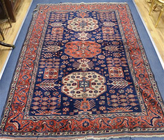 A Kazak blue ground rug, 8ft 3in by 5ft 7in.